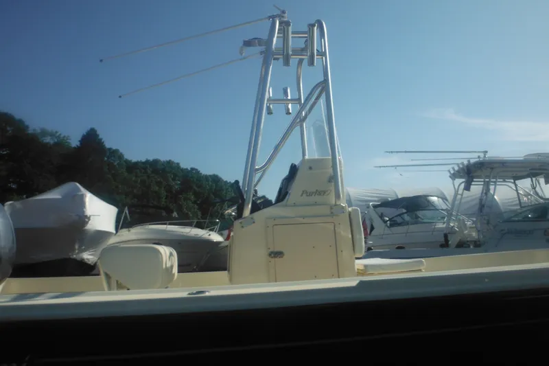 Slide: The Image of 2001 Parker 1801 Center Console boat docked under clear blue sky. - 10
