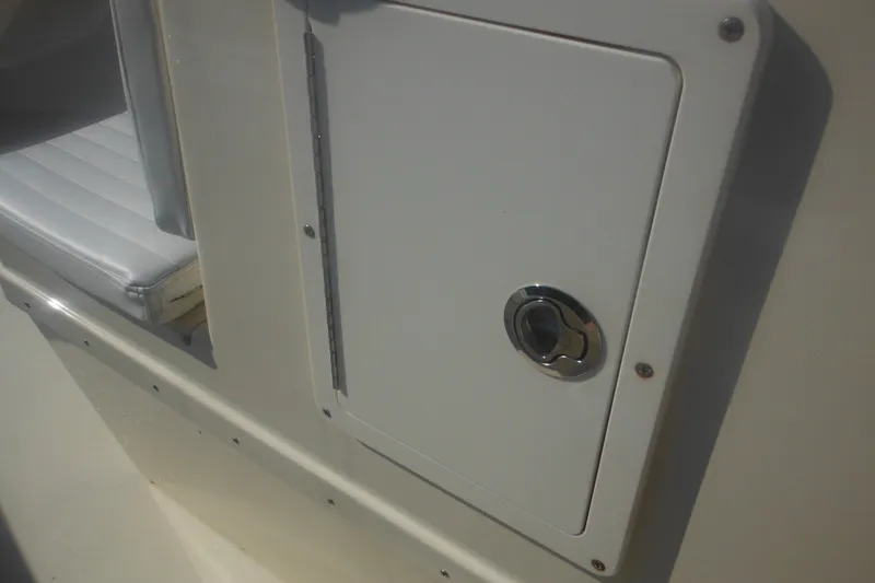 Slide: The Image of Close-up of a 2001 Parker 1801 Center Console boat compartment with latch. - 22