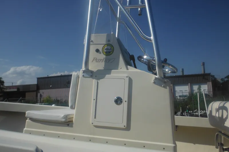 Slide: The Image of 2001 Parker 1801 Center Console boat with steering wheel and console, under clear blue sky. - 8