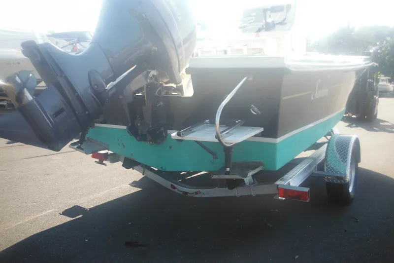 Slide: The Image of 2001 Parker 1801 Center Console boat on trailer, featuring an outboard motor. - 6