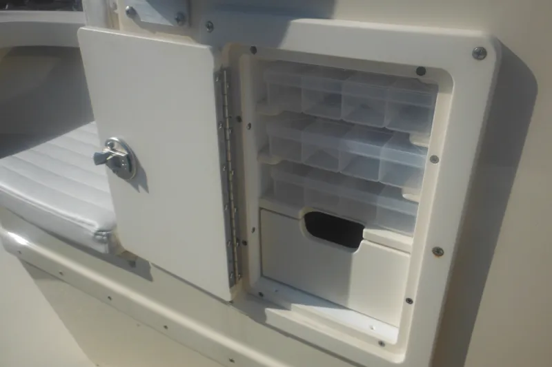 Slide: The Image of Open storage compartment on a 2001 Parker 1801 Center Console boat. - 23