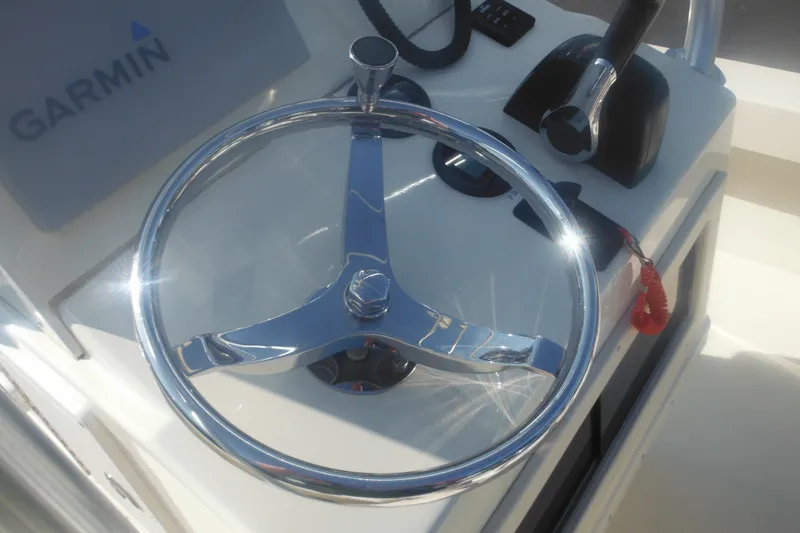 Slide: The Image of Steering wheel of a 2001 Parker 1801 Center Console boat with Garmin equipment. - 34