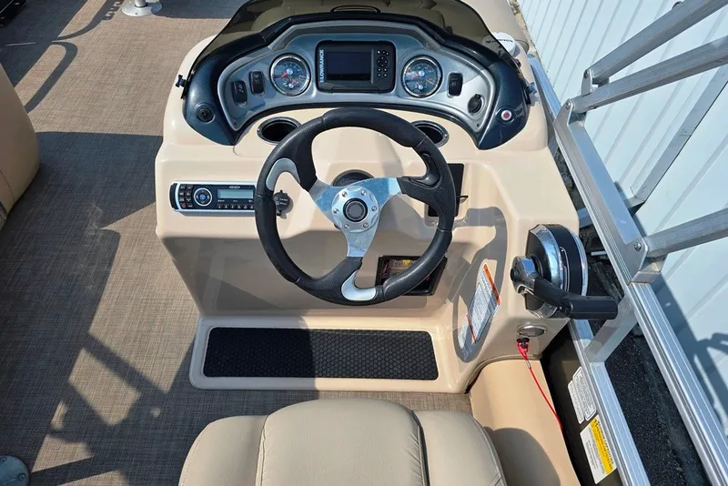Slide: The Image of 2019 Sun Tracker Fishin' Barge 22 XP3 helm with steering wheel and control panel. - 14