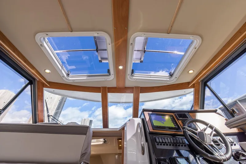 Slide: The Image of Manufacturer Provided Image: Interior view of 2025 Cutwater C-288 Coupe with skylights and modern helm. - 14
