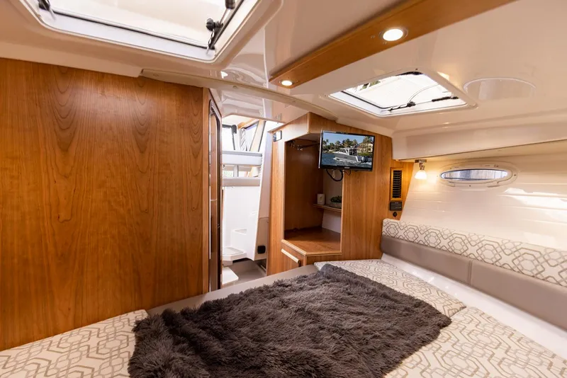 Slide: The Image of Manufacturer Provided Image: Luxurious interior of 2025 Cutwater C-288 Coupe with cozy bedding and modern amenities. - 20