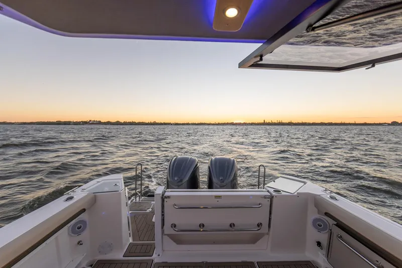 Slide: The Image of Manufacturer Provided Image: Cutwater C-288 Coupe 2025 boat at sunset, featuring dual engines and open water view. - 15