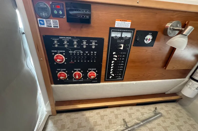 Slide: The Image of Control panel of 2025 Cutwater C-288 Coupe boat, featuring essential circuits and switches. - 13