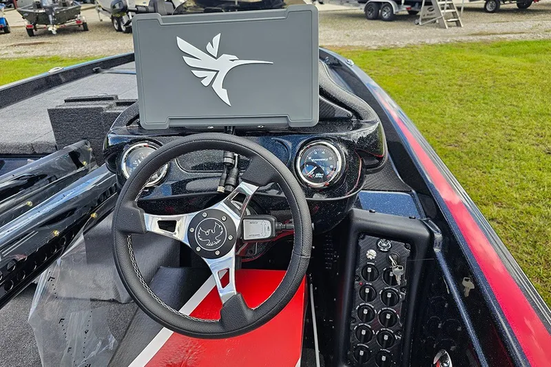 Slide: The Image of Cockpit view of 2027 Phoenix 721 ZXL boat with steering wheel and dashboard controls. - 18