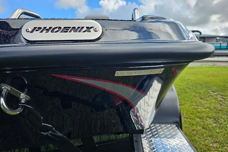 Slide: The Image of Close-up of 2027 Phoenix 721 ZXL boat with logo and sleek design. - 23