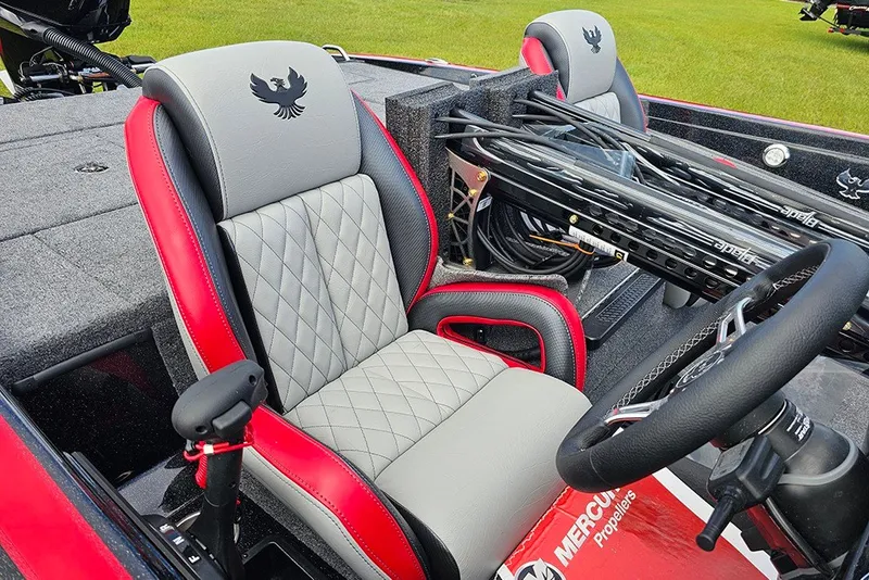 Slide: The Image of 2027 Phoenix 721 ZXL boat interior with red and gray seats, steering wheel, and fishing rods. - 20