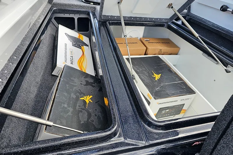 Slide: The Image of Storage compartments in a 2027 Phoenix 721 ZXL boat with Humminbird electronics boxes. - 17