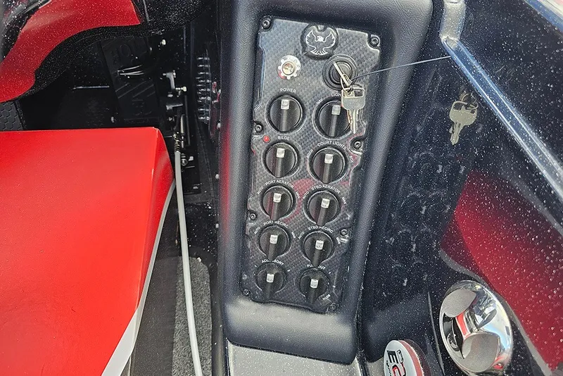 Slide: The Image of Control panel of a 2027 Phoenix 721 ZXL boat with switches and keys. - 19