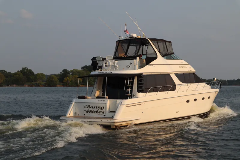 Slide: The Image of 1999 Carver Yacht Voyager 530 cruising on a serene lake. - 3