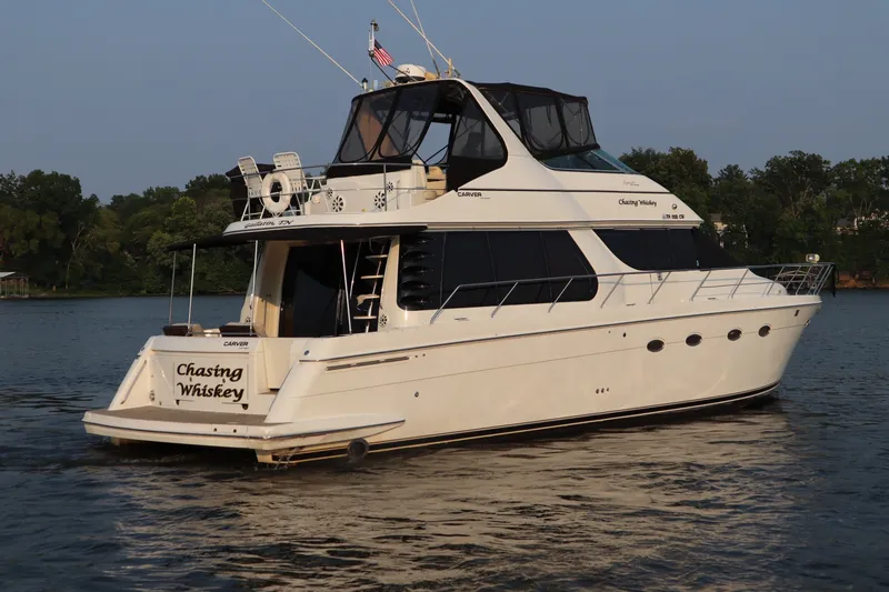Slide: The Image of 1999 Carver Yacht Voyager 530 on water, rear view, named "Chasing Whiskey." - 5
