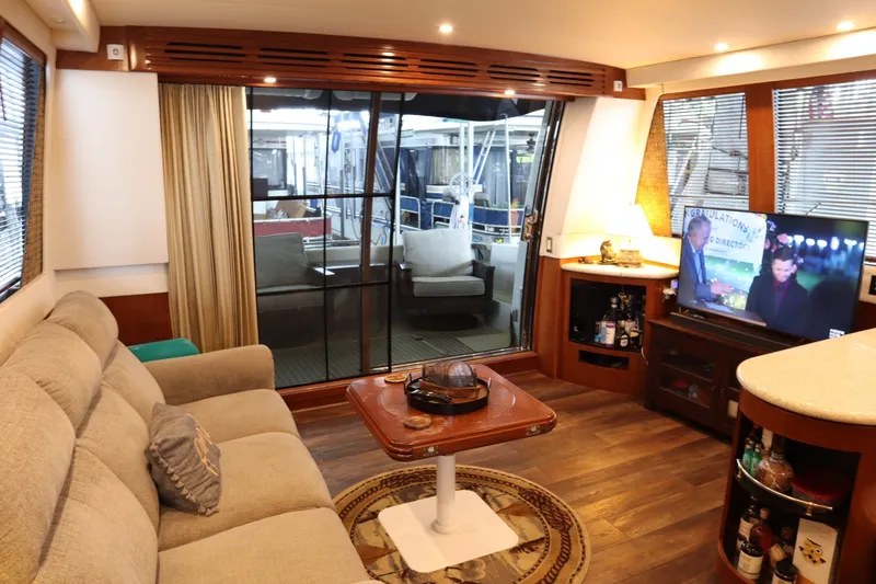 Slide: The Image of Luxurious interior of 1999 Carver Yacht Voyager 530 with cozy seating and entertainment area. - 13