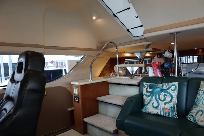 Slide: The Image of Interior of 1999 Carver Yacht Voyager 530 with leather seating and nautical decor. - 22