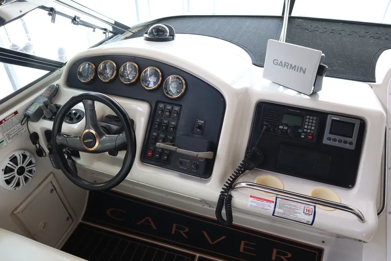 Slide: The Image of 1999 Carver Yacht Voyager 530 helm with Garmin navigation and control panel. - 34