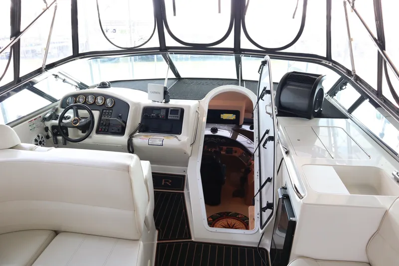 Slide: The Image of Interior view of a 1999 Carver Yacht Voyager 530 helm with modern navigation equipment. - 35