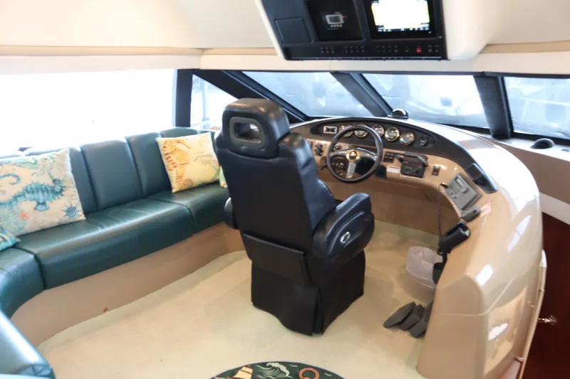 Slide: The Image of Interior of 1999 Carver Yacht Voyager 530 with helm and seating area. - 26