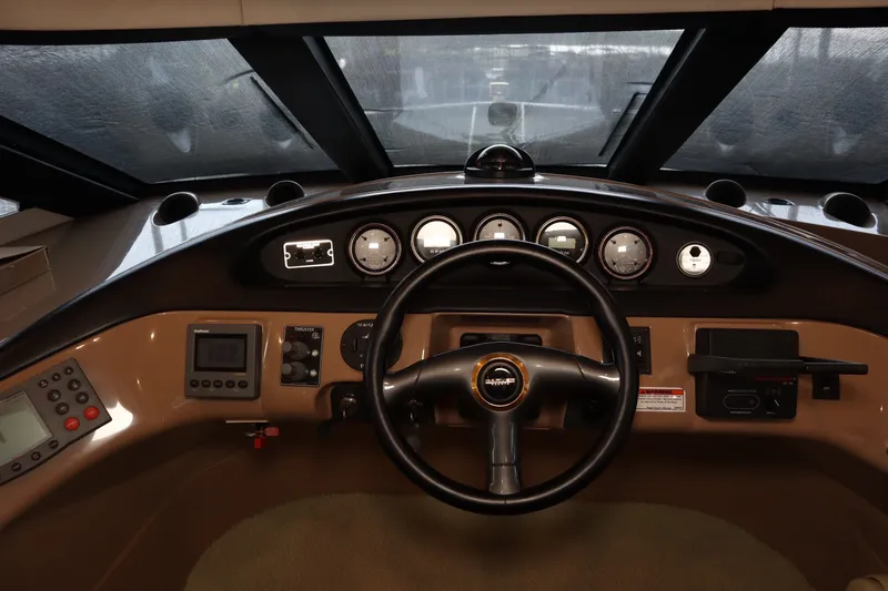 Slide: The Image of 1999 Carver Yacht Voyager 530 helm with steering wheel and instrument panel. - 23
