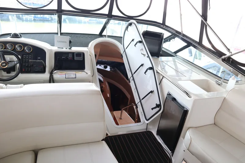 Slide: The Image of Interior of 1999 Carver Yacht Voyager 530, featuring helm, seating, and cabin entrance. - 33