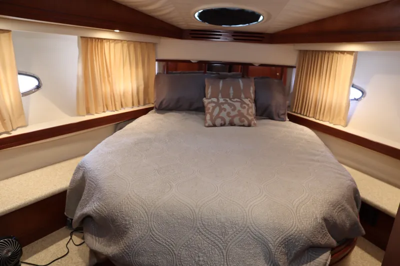 Slide: The Image of Luxurious bedroom interior of 1999 Carver Yacht Voyager 530 with elegant bedding and soft lighting. - 40