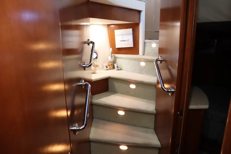 Slide: The Image of Interior staircase of 1999 Carver Yacht Voyager 530 with elegant wood finish and lighting. - 37