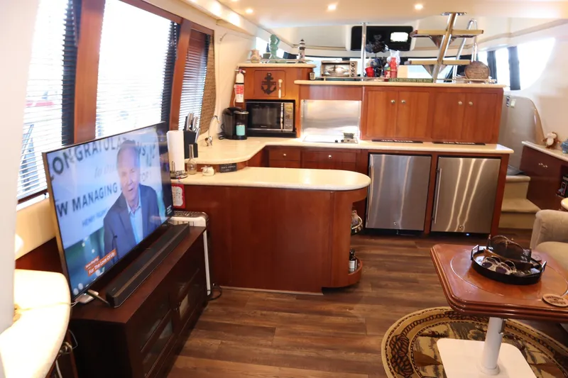 Slide: The Image of Luxurious interior of a 1999 Carver Yacht Voyager 530 with modern amenities and elegant wood finishes. - 14