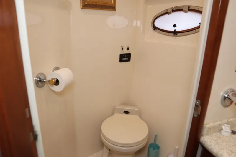 Slide: The Image of Bathroom interior of 1999 Carver Yacht Voyager 530 with toilet and porthole window. - 18