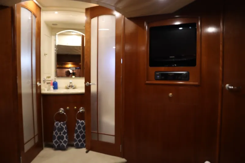 Slide: The Image of Interior of 1999 Carver Yacht Voyager 530 with wood paneling and bathroom view. - 15