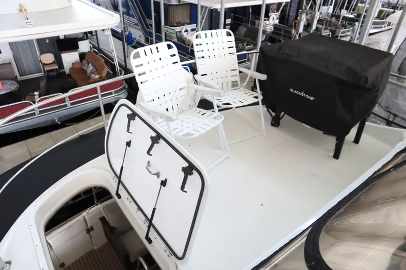 Slide: The Image of 1999 Carver Yacht Voyager 530 deck with chairs and covered grill. - 31