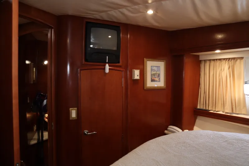 Slide: The Image of Interior of 1999 Carver Yacht Voyager 530 with wood paneling and vintage TV. - 39