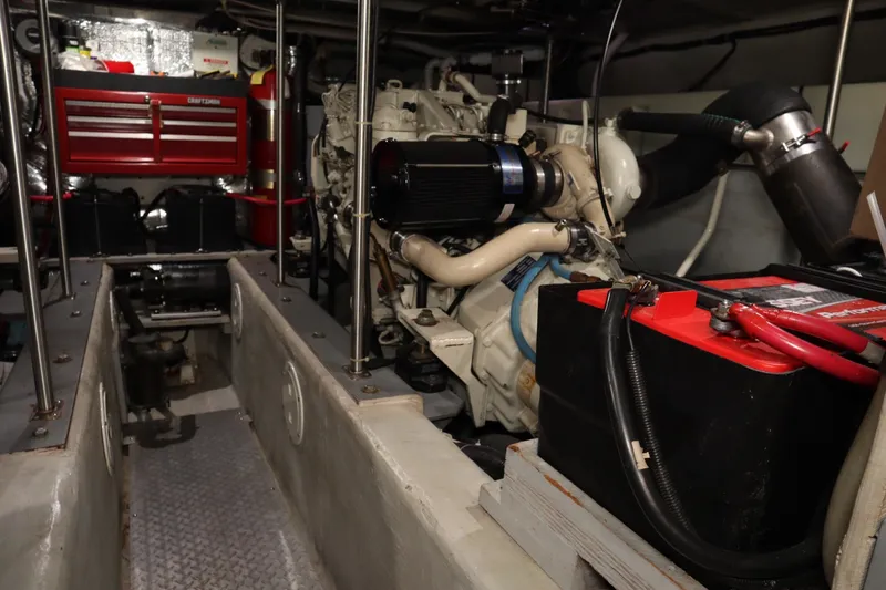 Slide: The Image of Engine room of a 1999 Carver Yacht Voyager 530, featuring machinery and battery. - 29