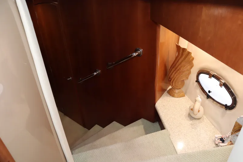 Slide: The Image of Staircase in 1999 Carver Yacht Voyager 530 with elegant decor and porthole window. - 21