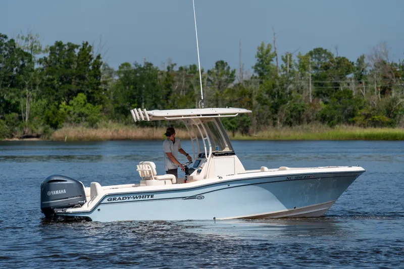 Slide: The Image of 2018 Grady-White Fisherman 216 boat cruising on a calm river with lush greenery. - 13