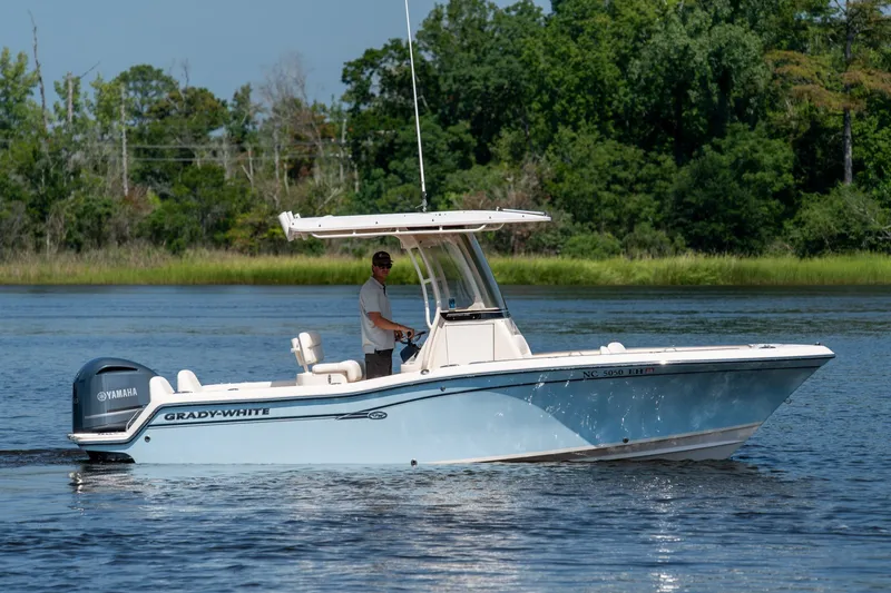Slide: The Image of 2018 Grady-White Fisherman 216 boat on a calm lake with lush green background. - 9