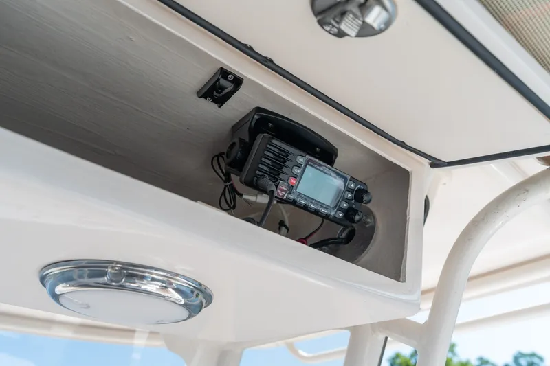 Slide: The Image of 2018 Grady-White Fisherman 216 boat radio compartment with electronic equipment. - 24
