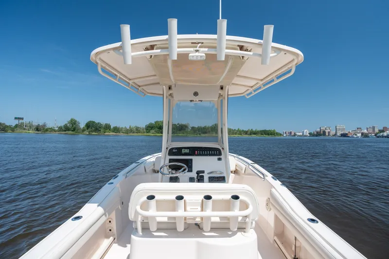 Slide: The Image of 2018 Grady-White Fisherman 216 boat on calm water under clear blue sky. - 18