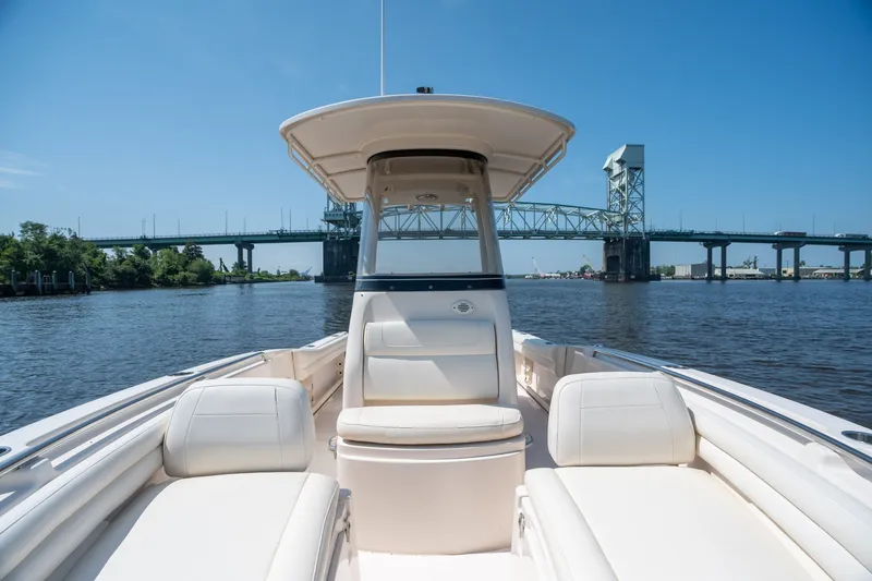 Slide: The Image of 2018 Grady-White Fisherman 216 boat cruising near a bridge on a sunny day. - 28