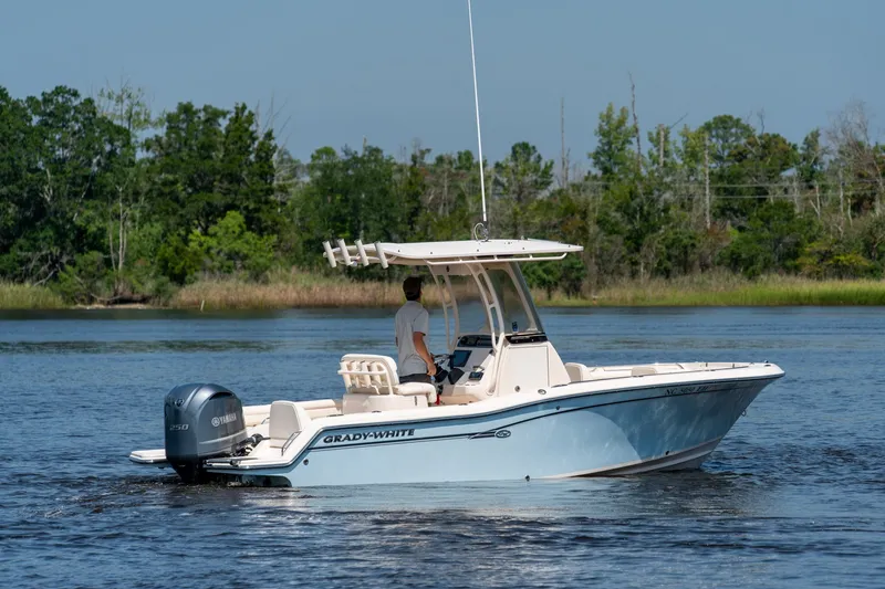 Slide: The Image of 2018 Grady-White Fisherman 216 boat cruising on a serene lake with lush greenery. - 8