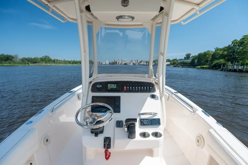 Slide: The Image of 2018 Grady-White Fisherman 216 boat dashboard on a scenic river. - 20