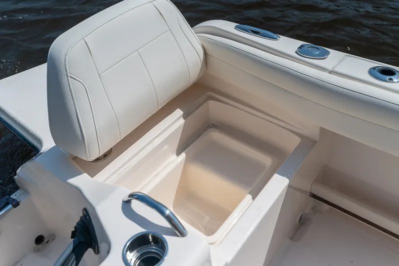 Slide: The Image of 2018 Grady-White Fisherman 216 boat seat with storage compartment, on water. - 32