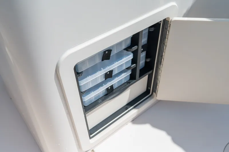 Slide: The Image of Storage compartment on 2018 Grady-White Fisherman 216 boat, featuring organized tackle boxes. - 19