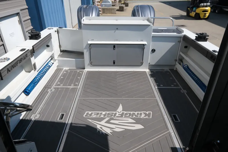 Slide: The Image of 2022 KingFisher 3425 GFX Offshore boat deck with storage compartments and logo. - 7