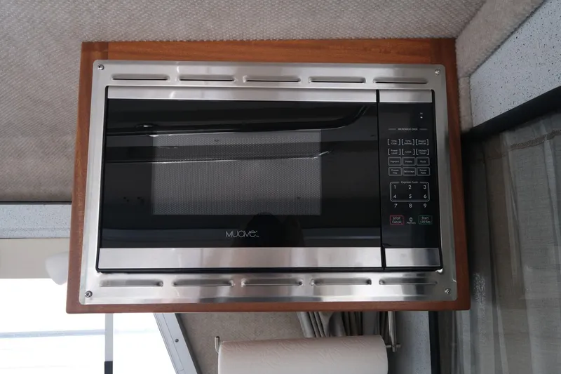 Slide: The Image of Built-in microwave in 2022 KingFisher 3425 GFX Offshore boat interior. - 17
