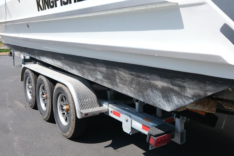 Slide: The Image of 2022 KingFisher 3425 GFX Offshore boat on a triple-axle trailer. - 21