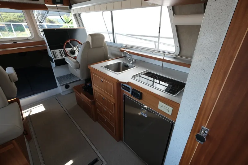 Slide: The Image of Interior of 2022 KingFisher 3425 GFX Offshore boat with kitchen and helm station. - 10