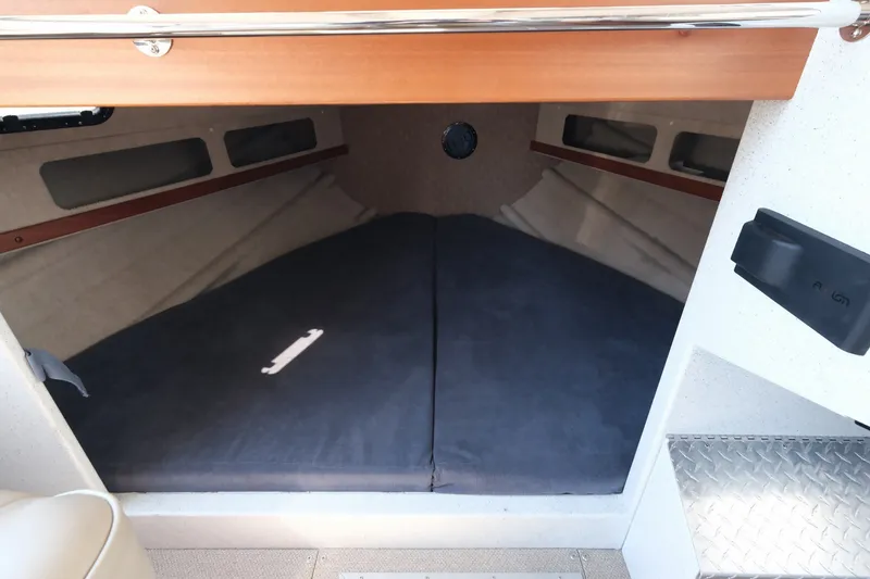 Slide: The Image of Interior cabin of 2022 KingFisher 3425 GFX Offshore boat, featuring a cozy sleeping area. - 13