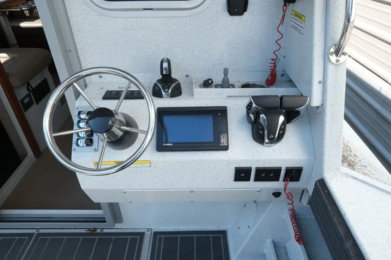 Slide: The Image of Helm of 2022 KingFisher 3425 GFX Offshore boat with steering wheel and controls. - 8