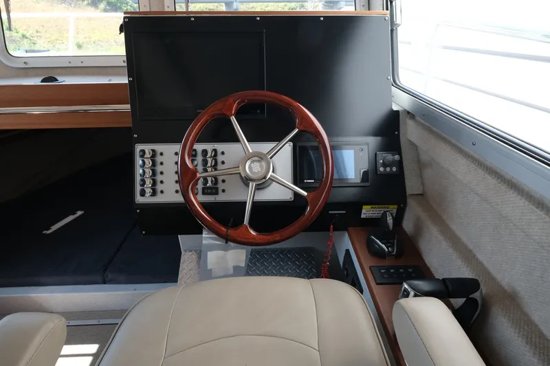 Slide: The Image of Interior helm of 2022 KingFisher 3425 GFX Offshore boat with steering wheel and controls. - 12